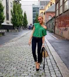 Light emerald green top with a shoulder and black skinny jeans