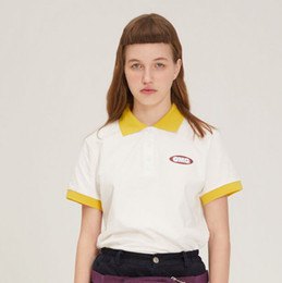 black jeans and white polo shirt with yellow collar