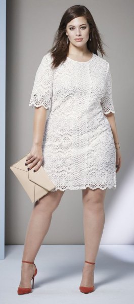 white lace dress with scalloped hem and red heels with ankle straps