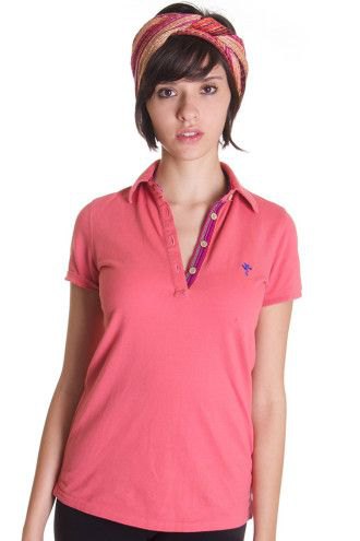 pink polo shirt with red headband and dark jeans