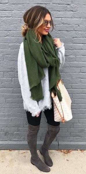 white sweater with green scarf and gray over the knee boots