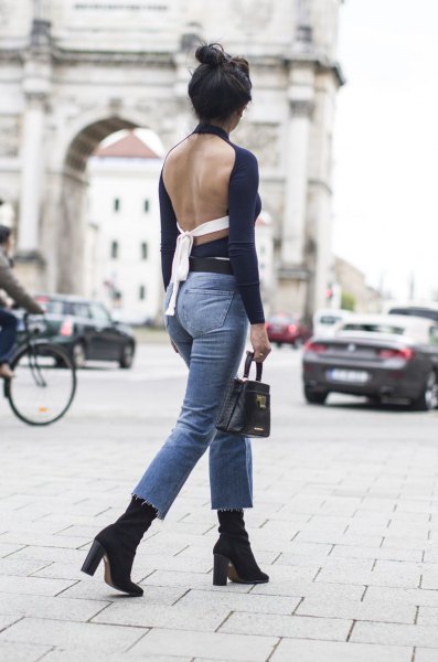 black backless long sleeve top with blue, slim fit ankle jeans