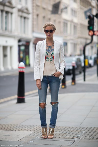white blazer with pink graphic t-shirt and torn jeans