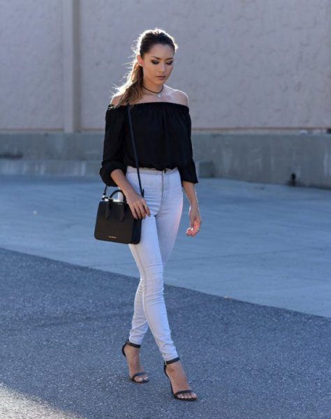 black, off-shoulder, short-cut blouse with white skinny jeans with high waist