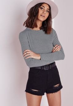 gray sweater with black shorts and white felt hat
