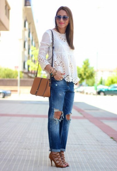 white long-sleeved blouse with torn jeans and red strappy lace-up shoes