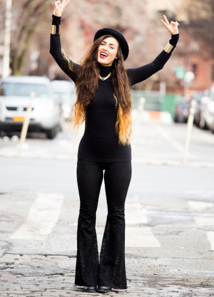 black figure-hugging sweater with matching flared jeans