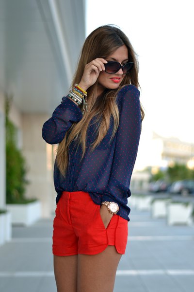 Navy polka dot shirt with buttons and red shorts