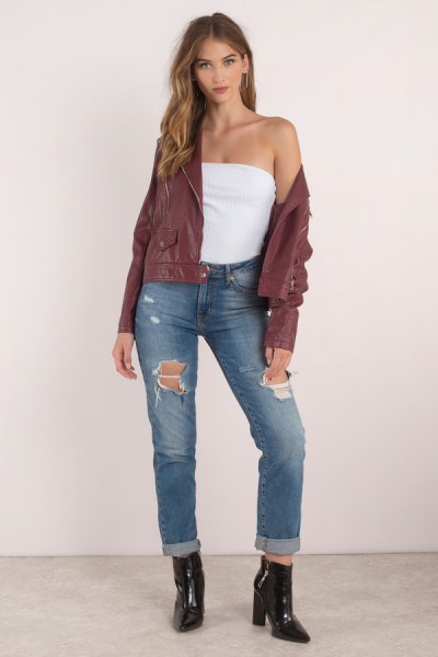 green bomber jacket with tube top and torn jeans with cuffs