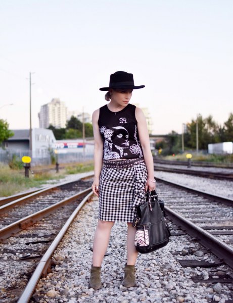 Graphic tank top with felt hat and checkered knee-length skirt