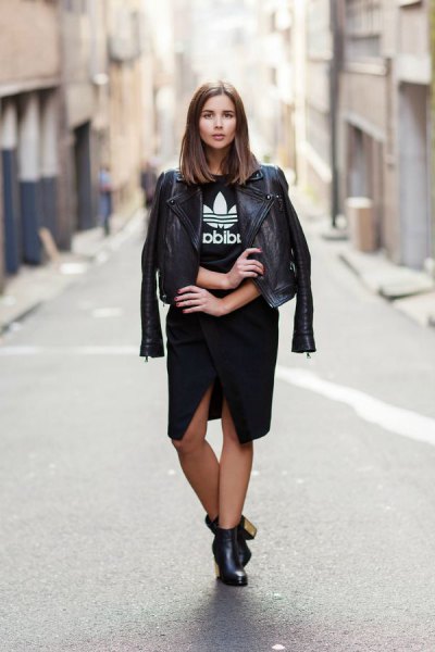 black leather jacket with graphic t-shirt and knee-length skirt