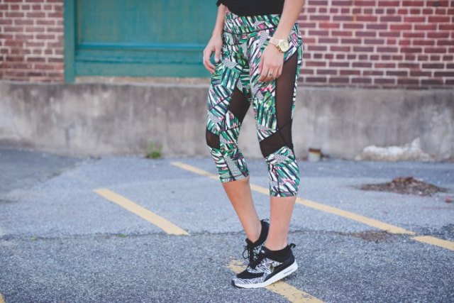 gray, short-cut mesh leggings with floral pattern and matching running shoes