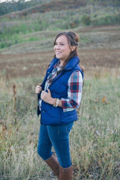 royal blue down vest with checkered boyfriend shirt and gray knee-high boots