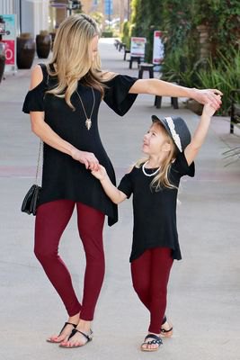 black tunic top with cold shoulder and burgundy leggings