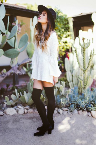 white long-sleeved blouse dress with tights and ankle boots