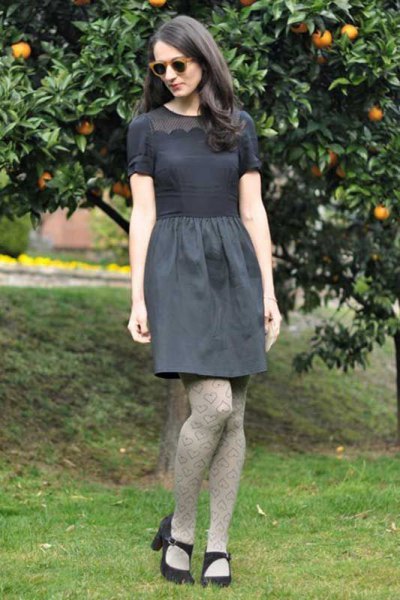 gray short-sleeved blouse with a relaxed knee-length skirt