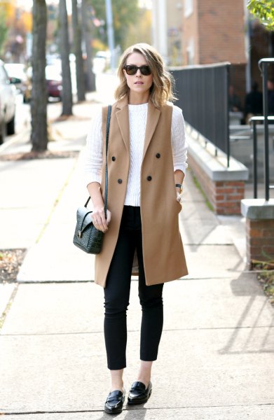 white cable knit sweater with red, sleeveless wool coat and loafers