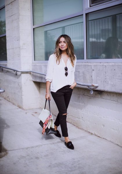 white three-quarter sleeved blouse with black, slim fit jeans