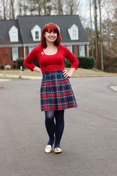 red submarine with a scoop neck and knee-length pleated skirt