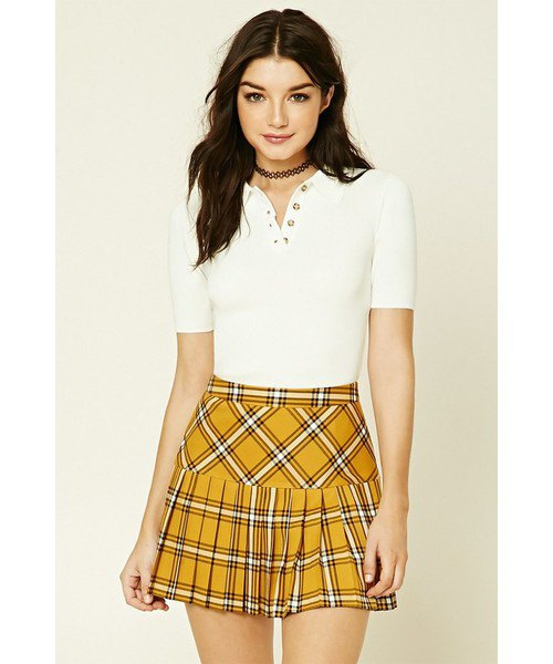 mustard yellow checked pleated mini skirt with white polo shirt