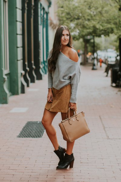 gray chunky sweater with a shoulder and light brown mini skirt