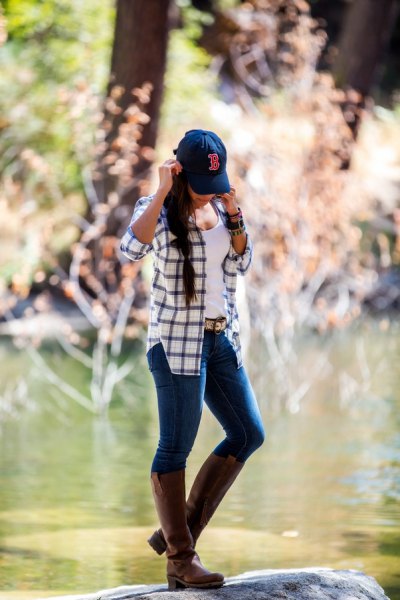 blue and white checked hiking jacket with gray knee-high leather boots