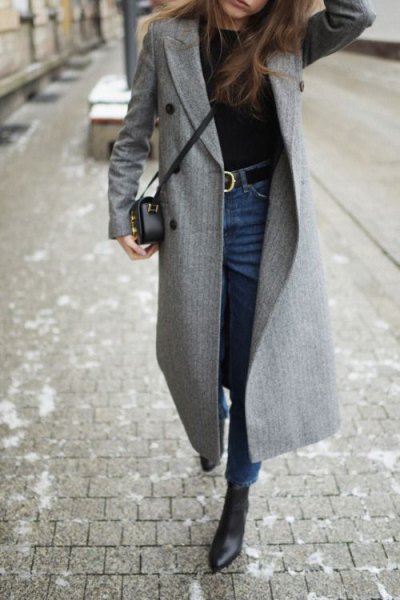 gray walker coat with blue skinny jeans with a high belt