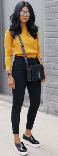 Mustard yellow, slightly shortened sweater with black ankle jeans