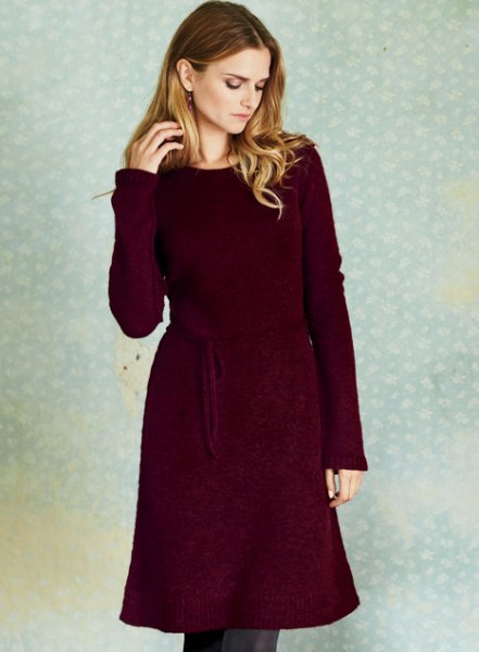 deep red long sleeve sweater dress with belt and skinny jeans