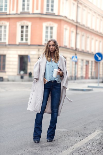 white long wool coat with light blue chambray shirt and dark blue flare jeans