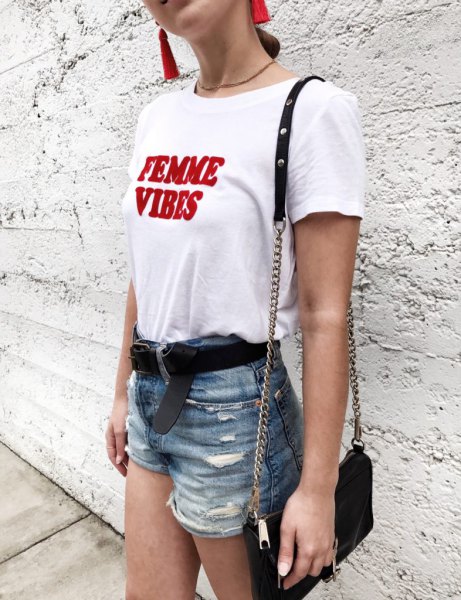 white and red graphic tee with blue high-rise ripped denim shorts