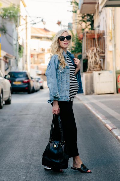 blue denim jacket with black and white striped top and black trousers with wide legs