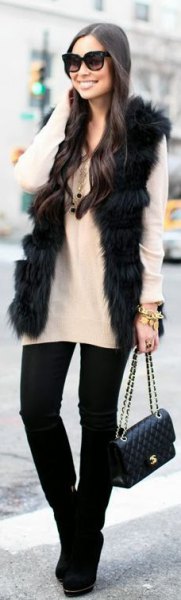 black fur vest with white sweater and black skinny jeans