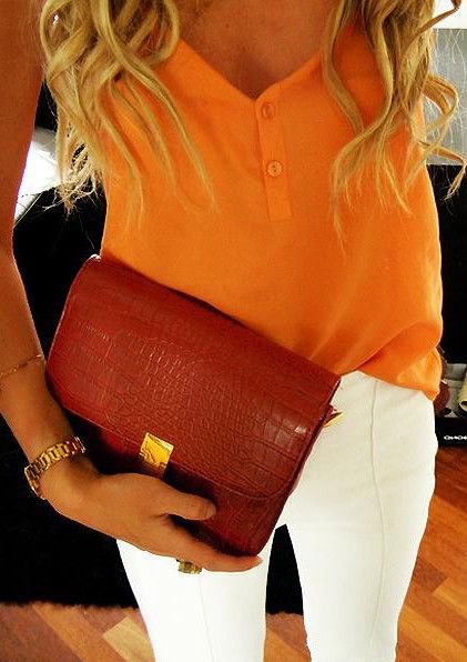 mustard yellow vest top with white skinny jeans and burgundy leather clutch bag