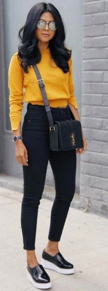 mustard cropped sweater with black slim fit jeans