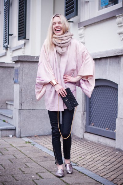 light pink chunky cardigan with black leather pants and gold metallic loafers