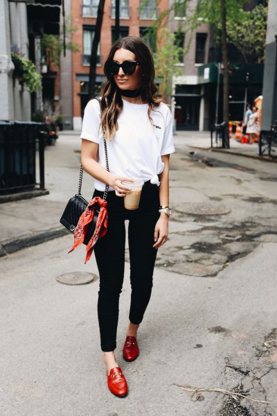 white knit tee with black skinny jeans and red leather boards