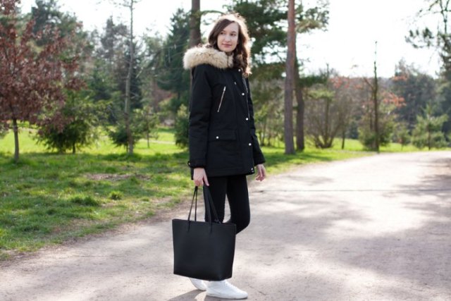 black faux fur hooded long jacket with matching jeans and sneakers