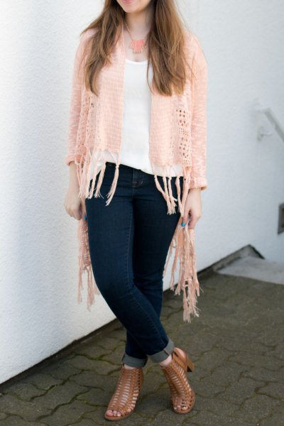 Ivory finely crochet cardigan with white scoop neck vest and dark blue skinny jeans