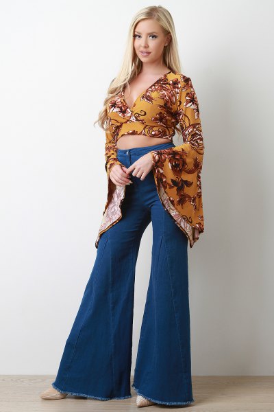 mustard yellow printed watch sleeve cropped blouse with blown-out jeans