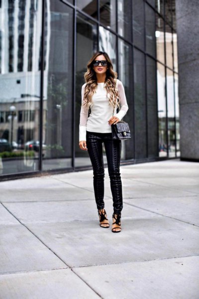 white form fitting long sleeve shirt with leather leggings and open toe heels