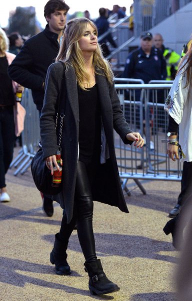 black long-line wool coat with leather pants and ankle boots