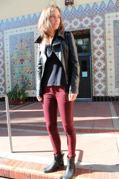 black leather jacket with green skinny jeans