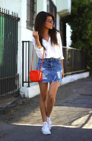white button up shirt with blue ripped mini denim skirt and small brown shoulder bag