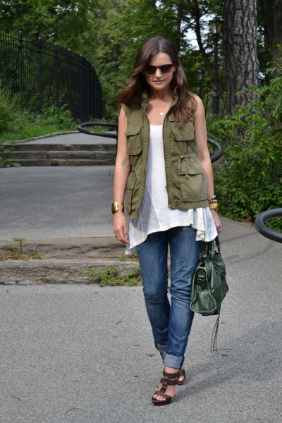 green work vest with white sleeveless tunic top and cuffed jeans