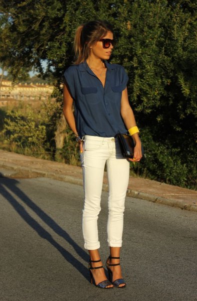 dark navy sleeveless blouse with white cuffed jeans