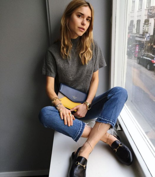 gray tee with cropped blue jeans and casual black loafers