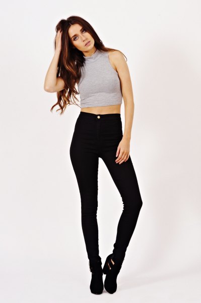 gray sleeveless crop top with black high waist skinny jeans