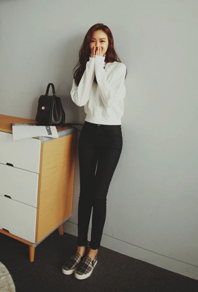 white sweater with black high waist slim jeans and plaid cloth shoes