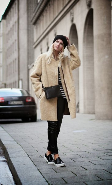 blush pink long wool coat with black leather pants and slip on cloth shoes